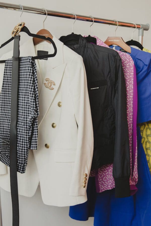 A rack of clothes and jackets hanging on the wall.